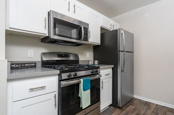 A kitchen with a black refrigerator, stove, and microwave. at 55+ FountainGlen Temecula, Temecula, CA, 92591